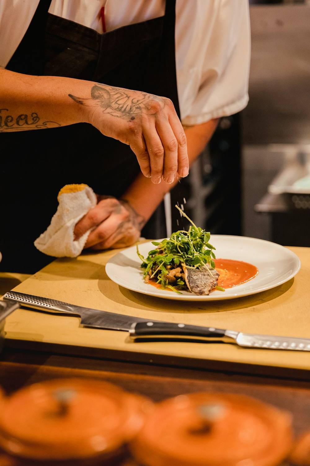 Chef finishing a plate in the kitchen
